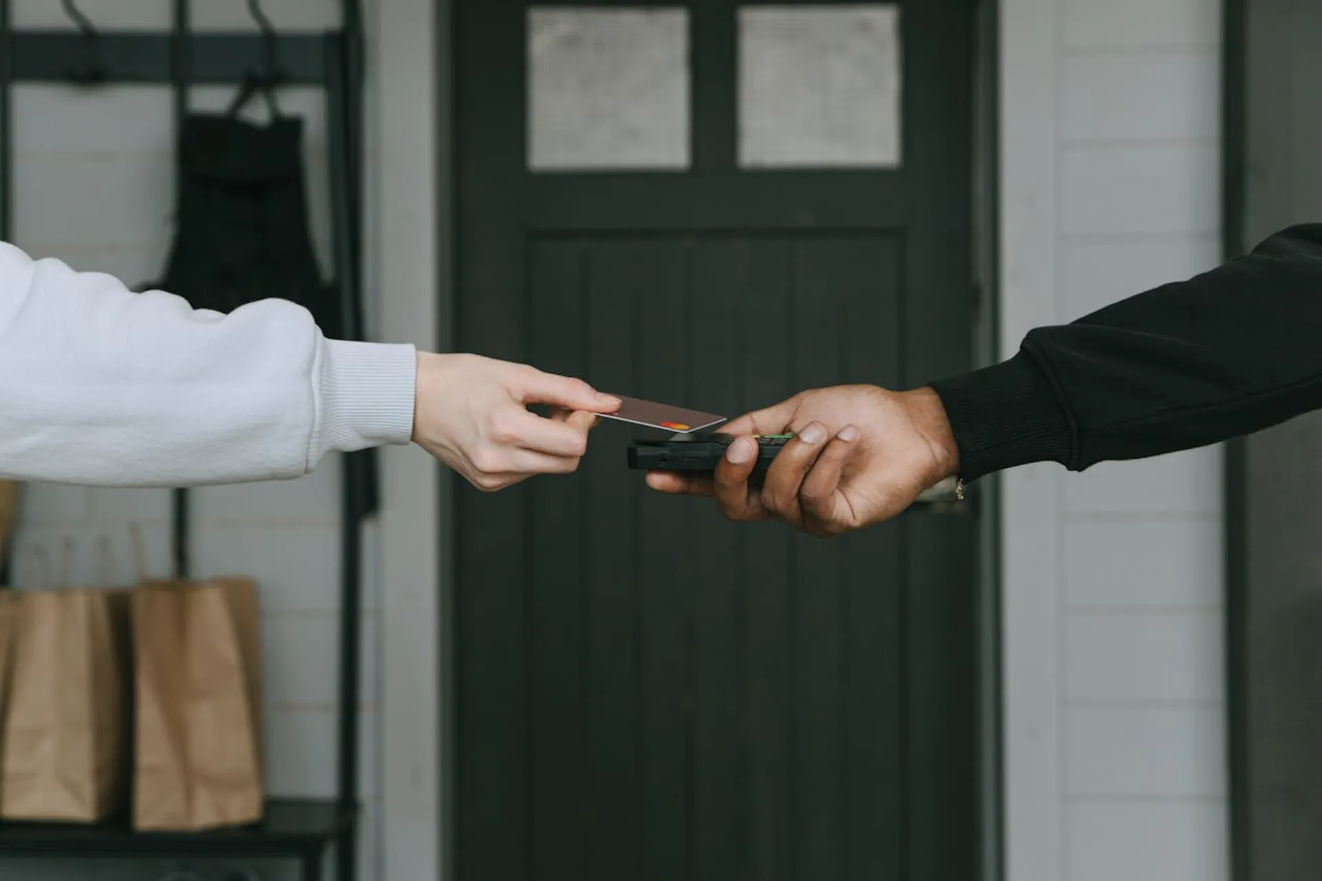 A merchant and customer completing a transaction to indicate credit card processing account royalty being earned