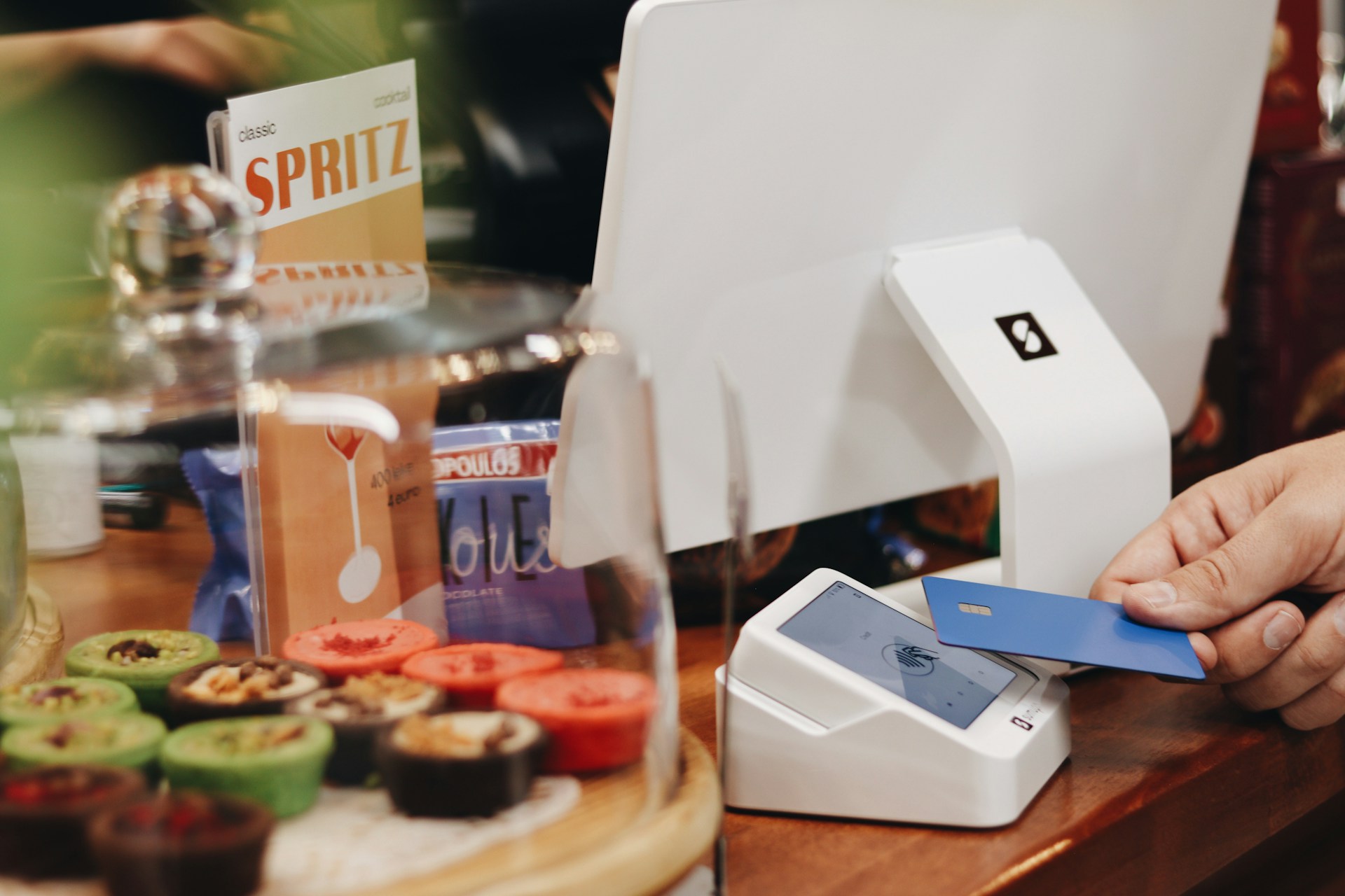 The payment counter of a business wondering “How to sell a merchant account portfolio?” as its pay portal is being used by a customer