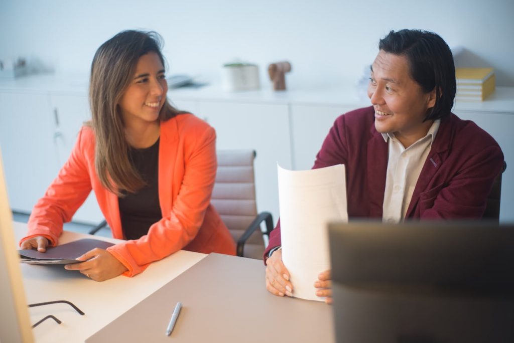 Two business professionals discussing selling a payment processing residual stream