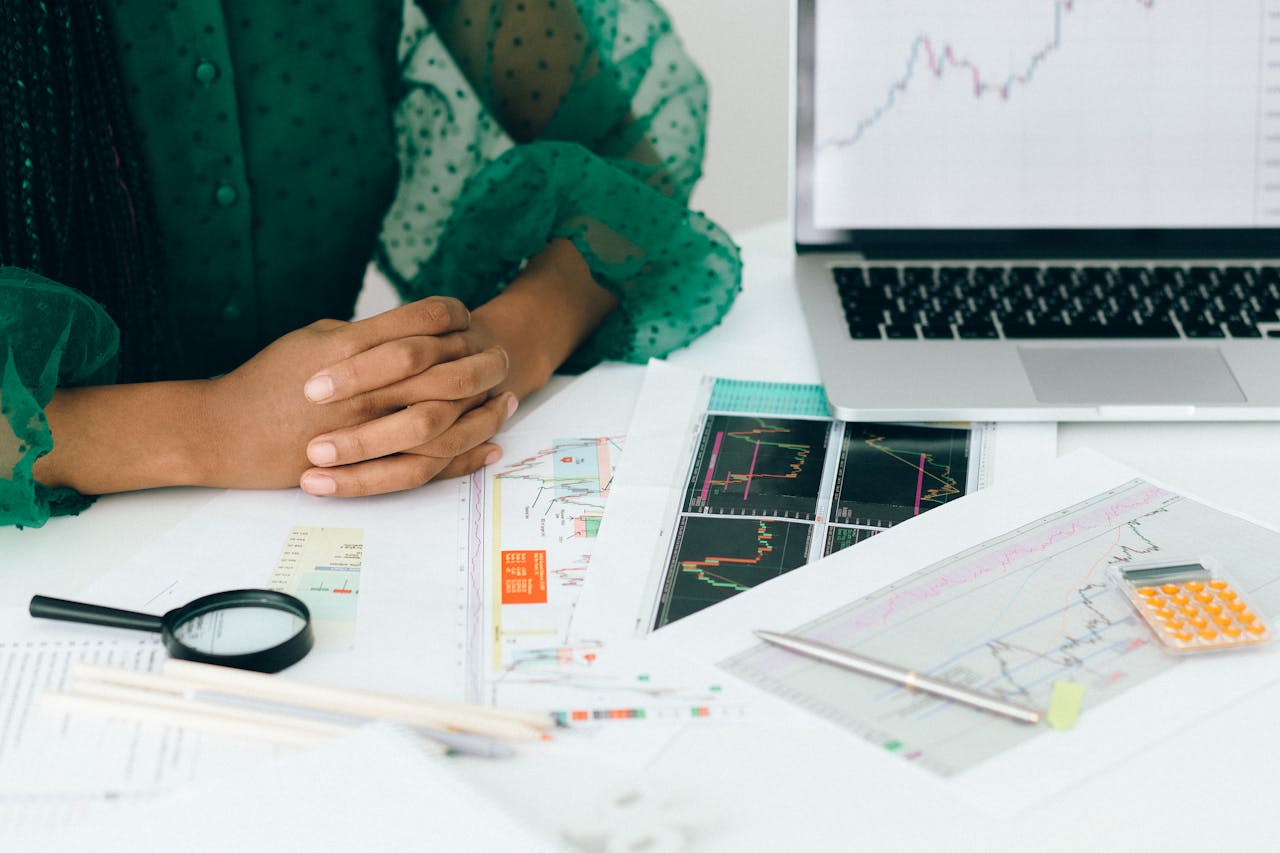 A person sitting at a table with papers on a desk containing information about 2025 merchant service portfolio trends
