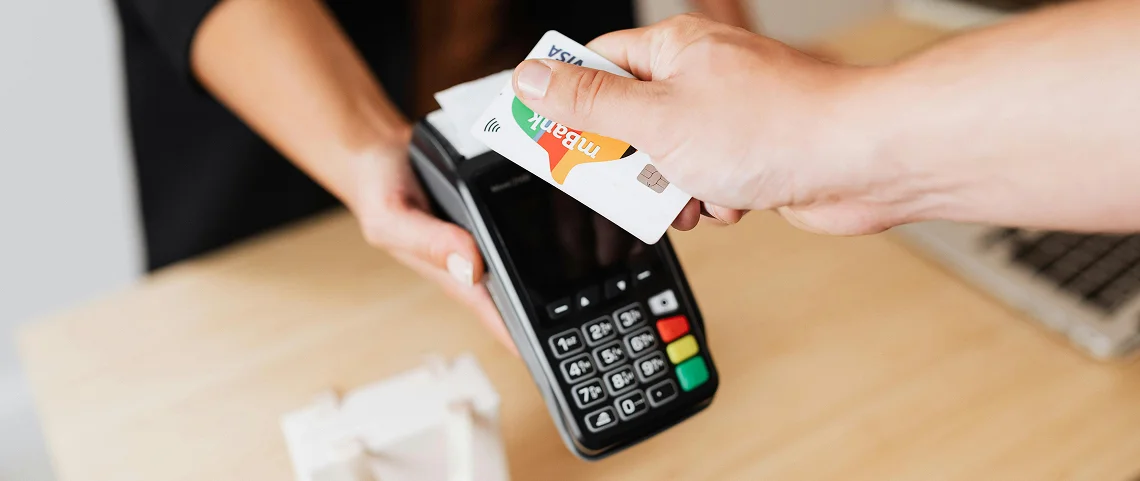 A customer using a credit card to pay for a product