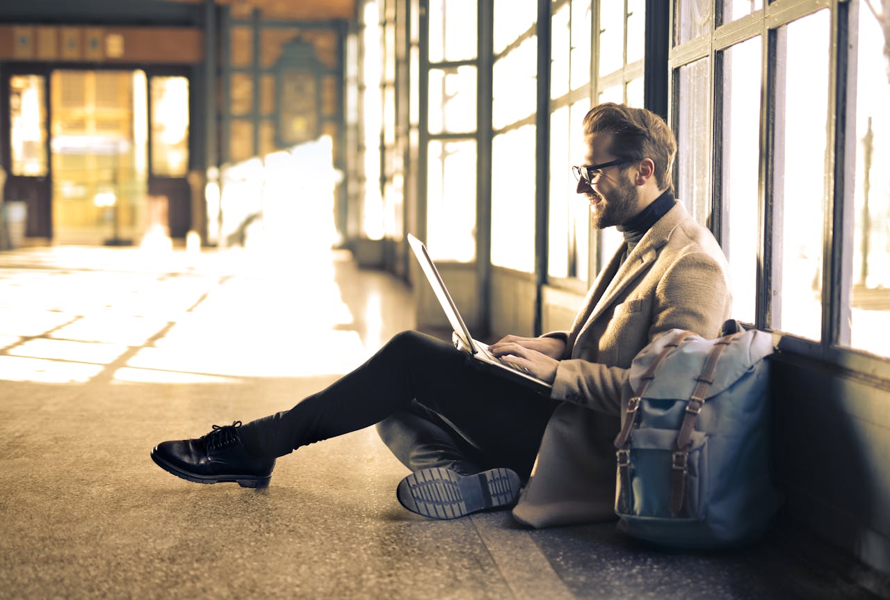 A smiling man using a laptop