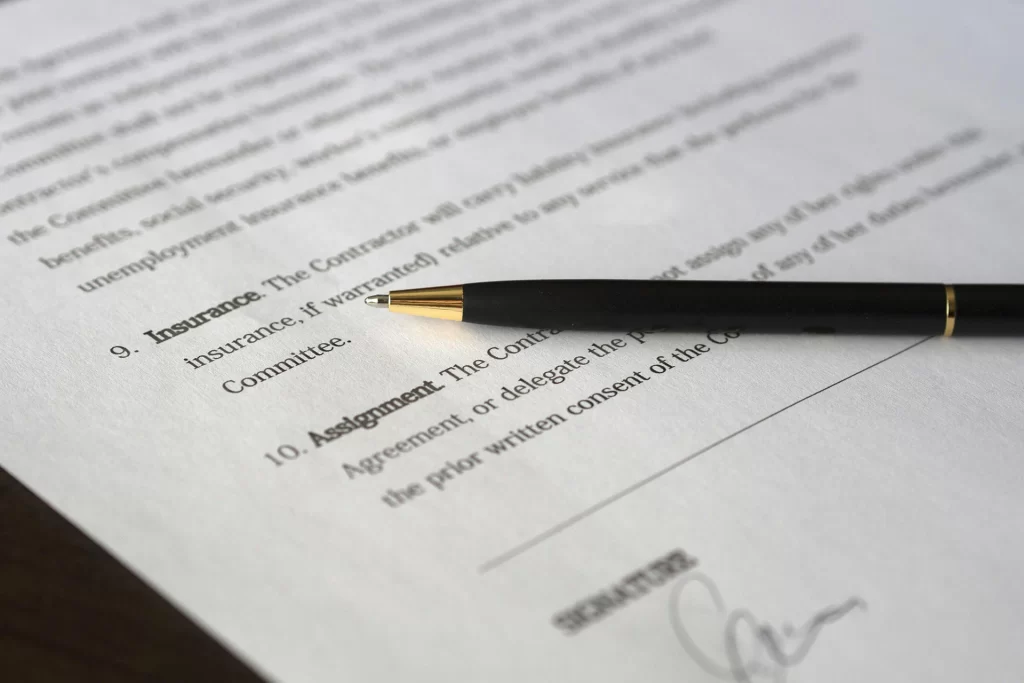 Contract terms on paper with a pen on top of the document
