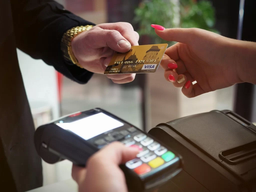 A person handing over a debit card