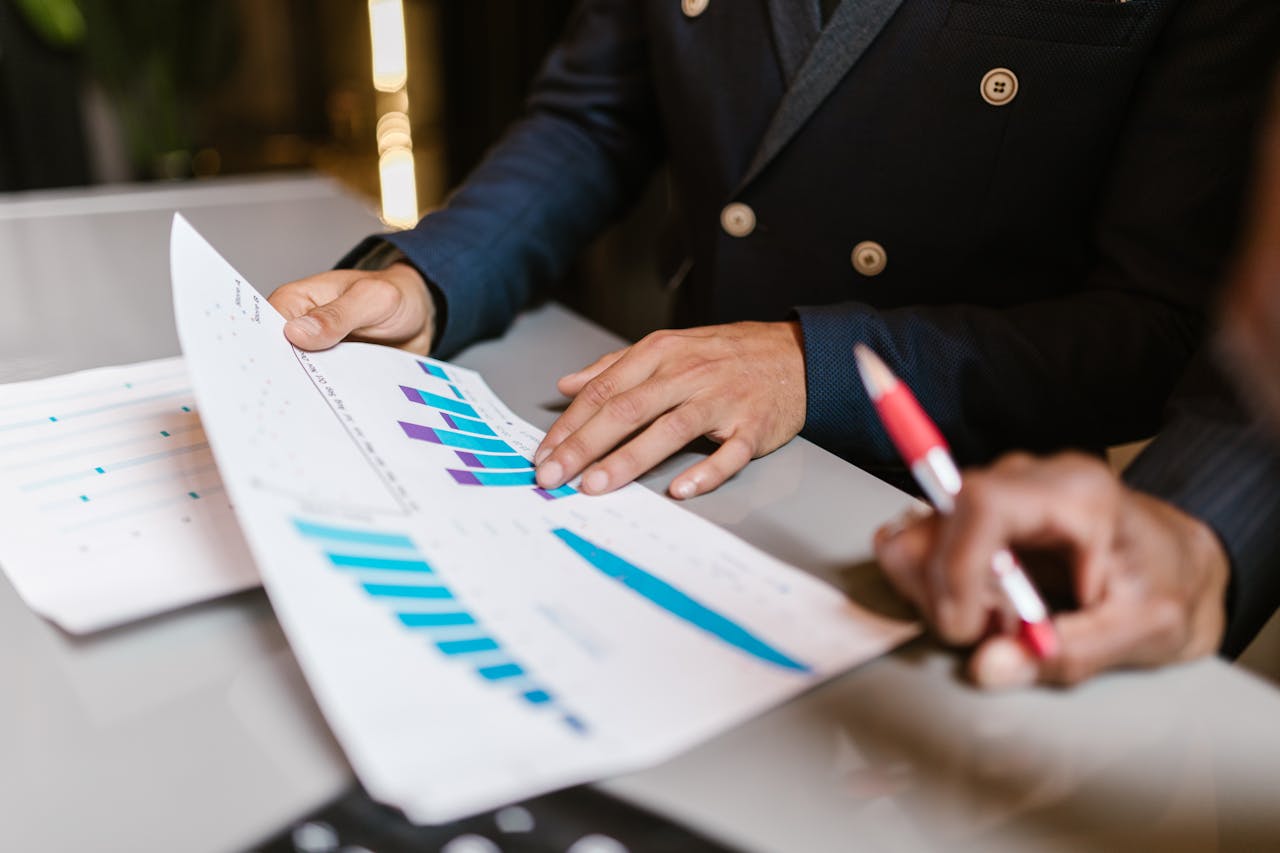 Two people sharing reports concerning how to grow a book of business