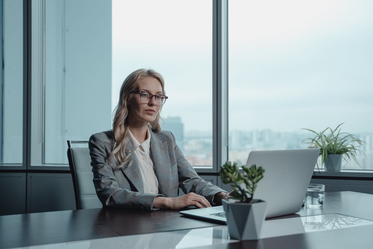 A woman using her laptop to research merchant services agent tips