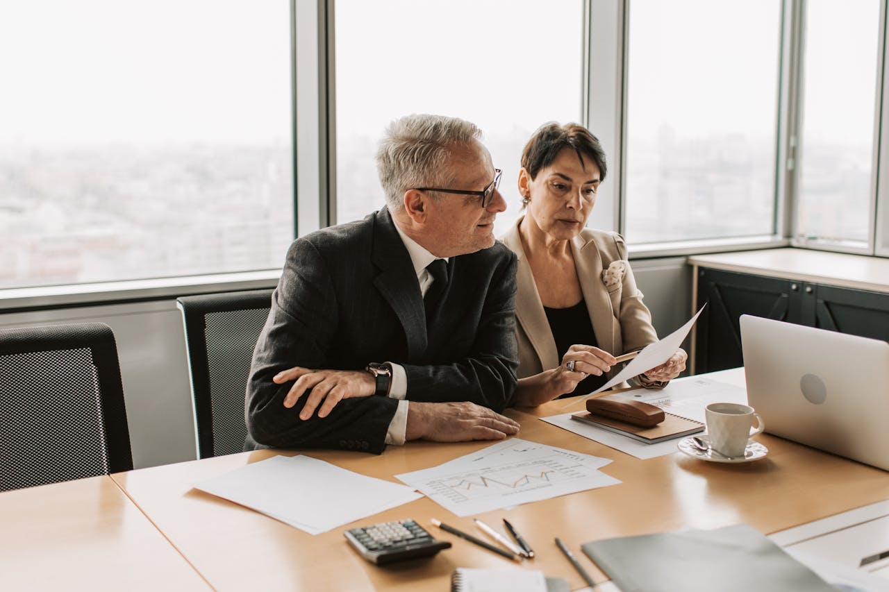 Two older businesspeople discussing new technologies and opportunities