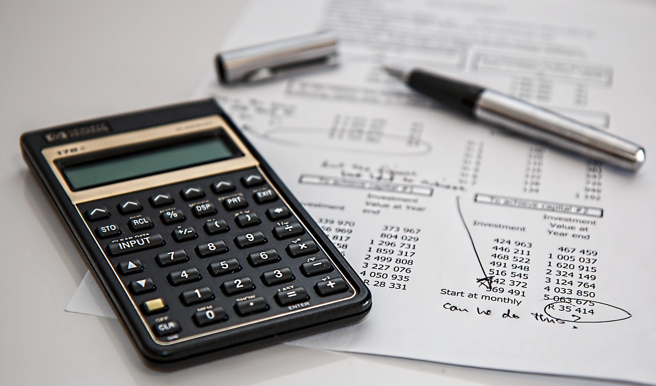 A calculator following a paper detailing monthly totals
