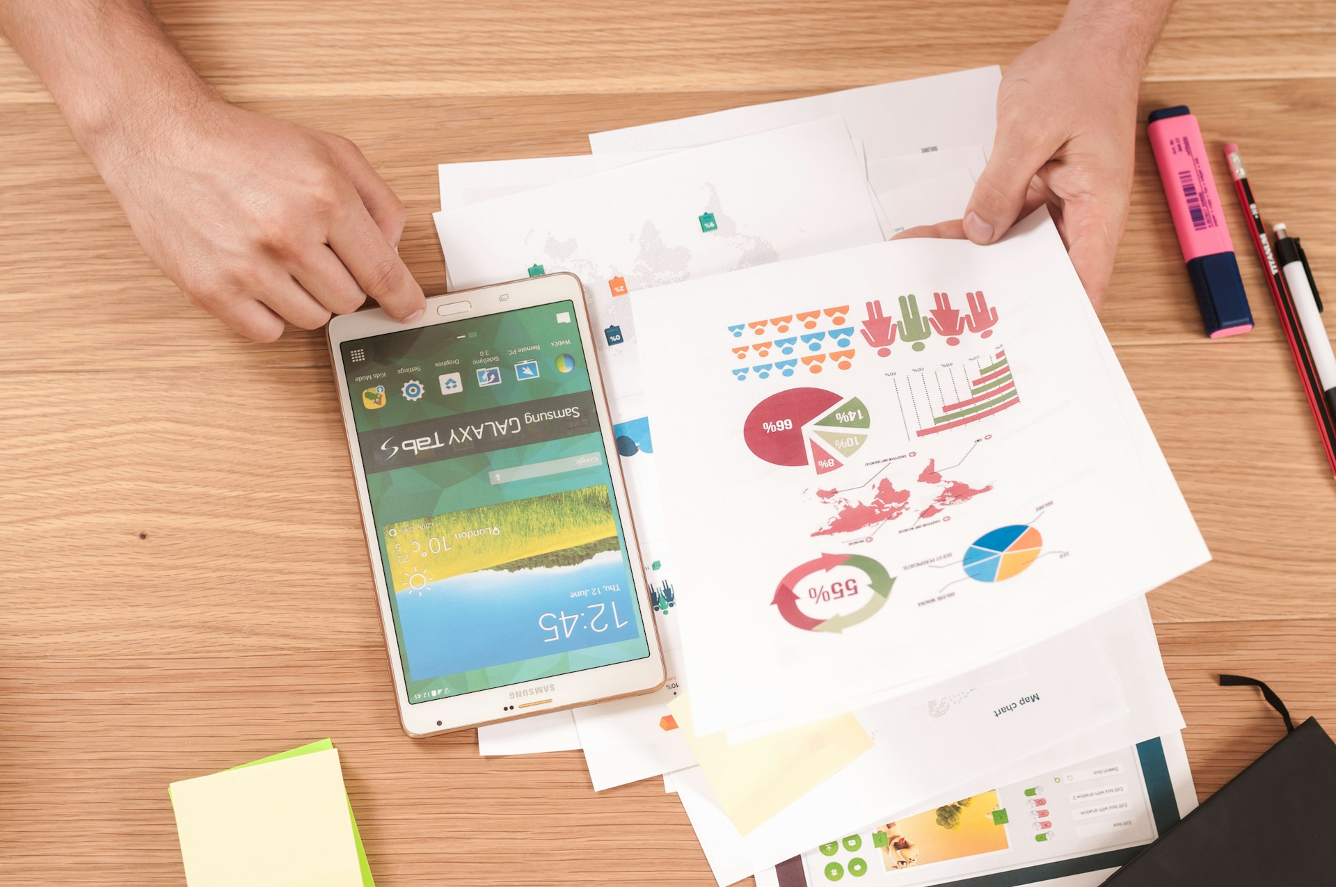 A person going over a stack of papers focused on portfolio optimization strategies
