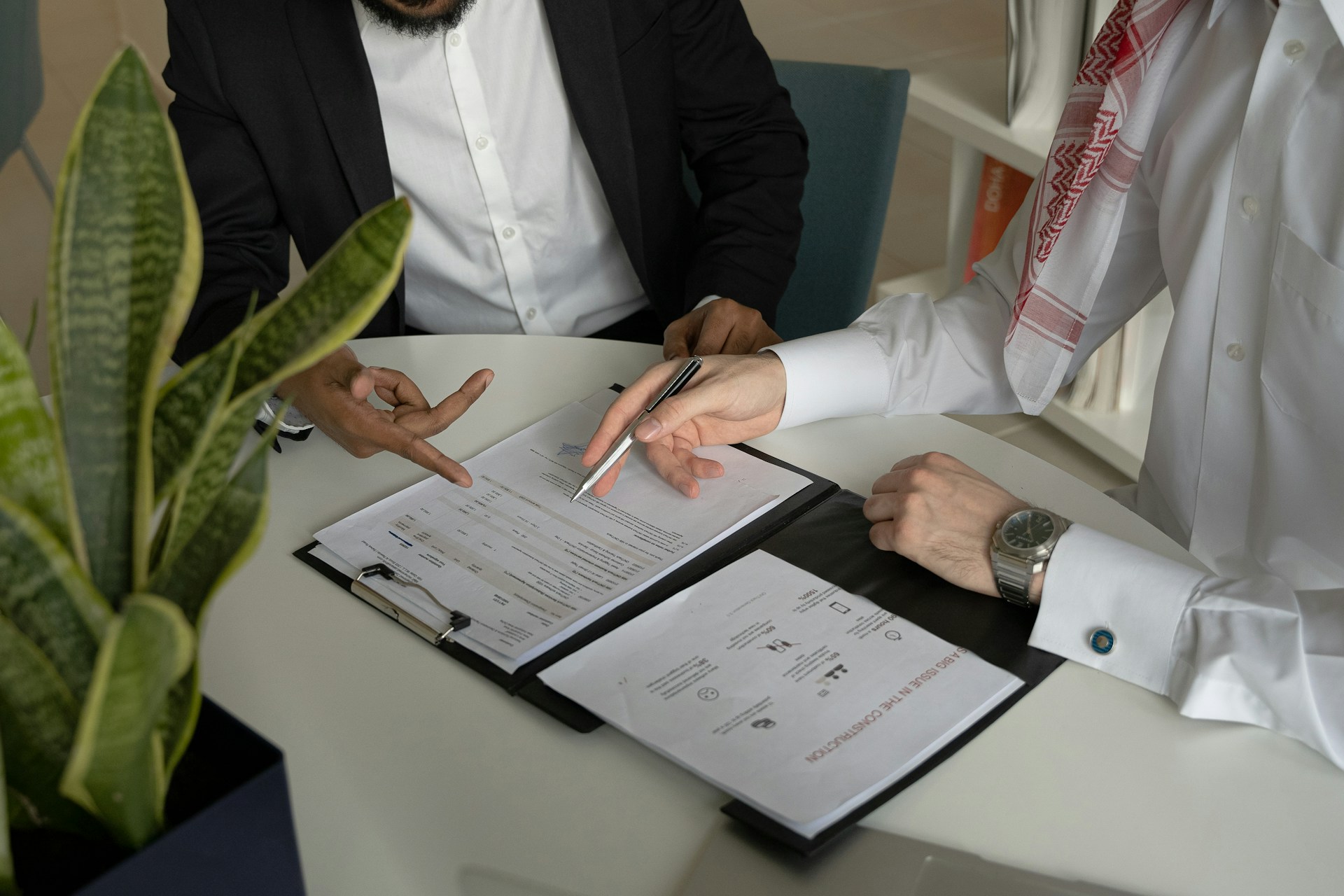 Two people sitting near papers that contain data
