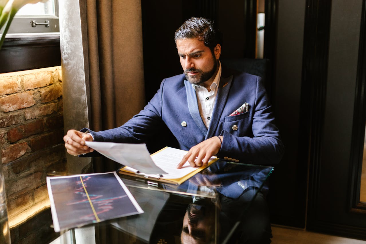 An executive going over his portfolio in a dimly-lit room