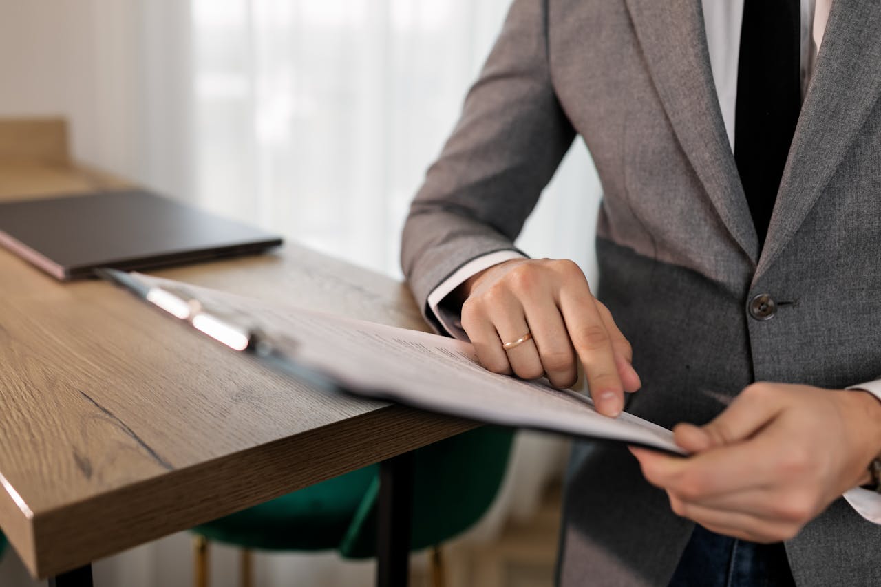 A person in a suit scanning a document about exit planning for ISO agents nearing retirement